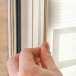 The,Man,Wipes,The,Window,Frame,With,A,Degreaser,And