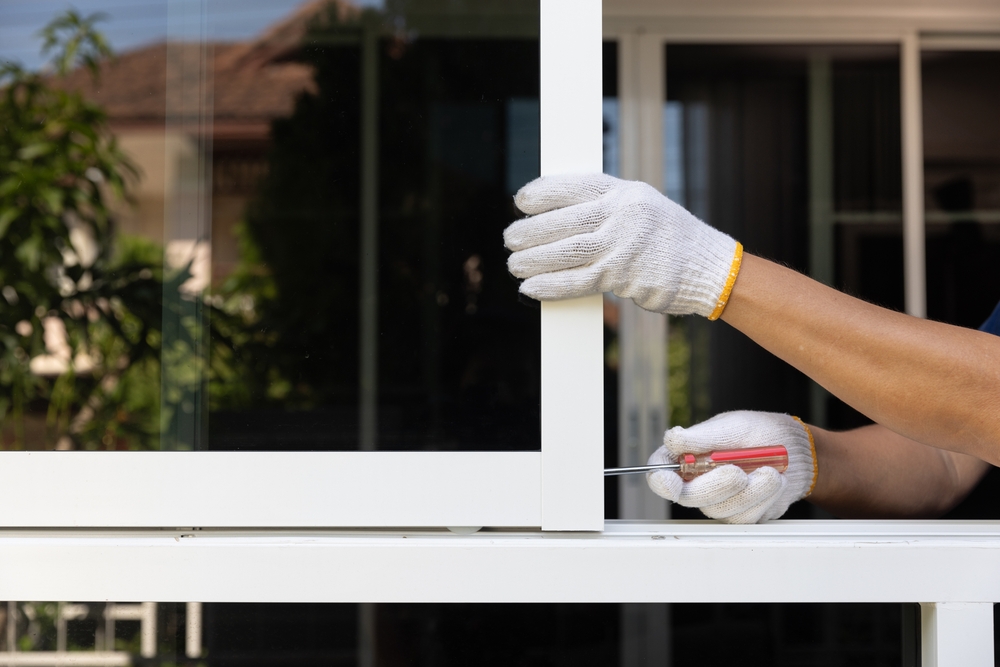 Handyman,Repairing,The,Sliding,Window.,Adjust,A,Rail,Wheel,And